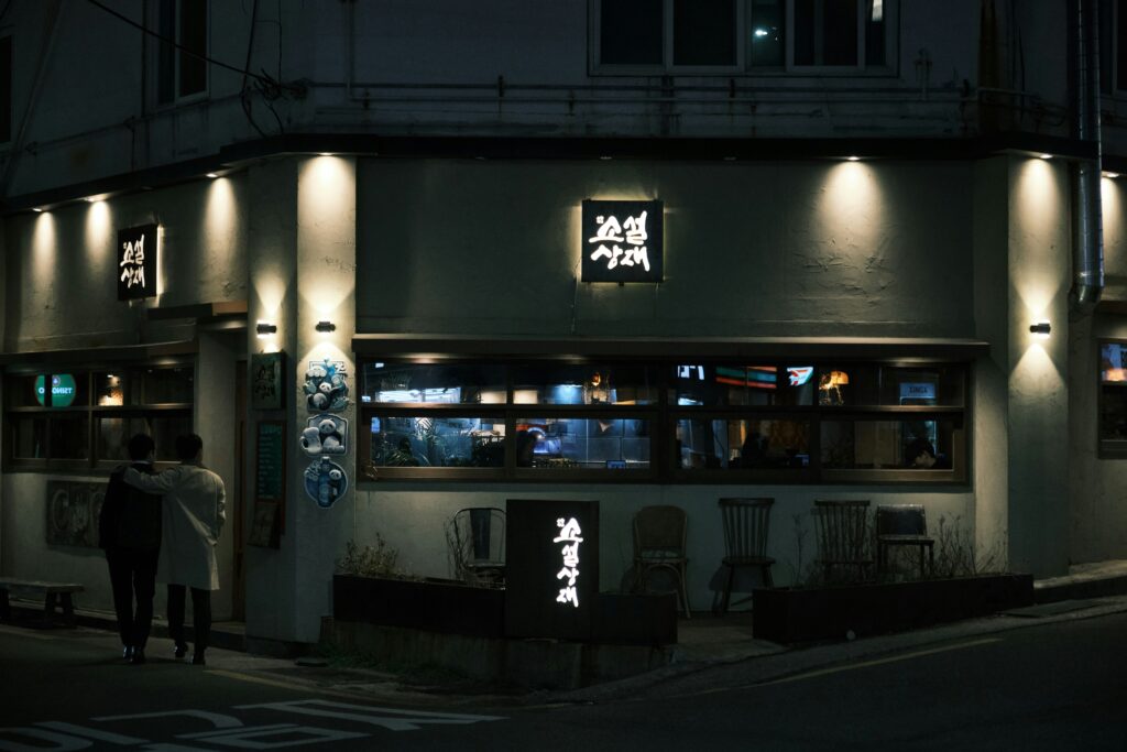 family writing Hangul characters in Korean restaurant, festive mood, realistic high quality photo