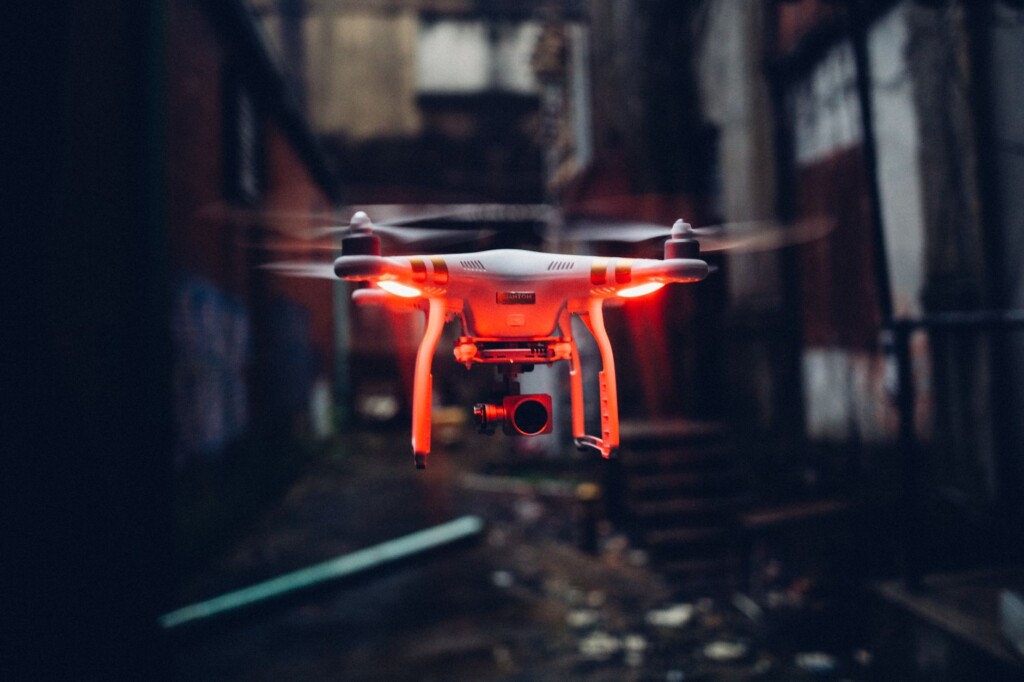 A surveillance drone hovering in a dark high-tech room
