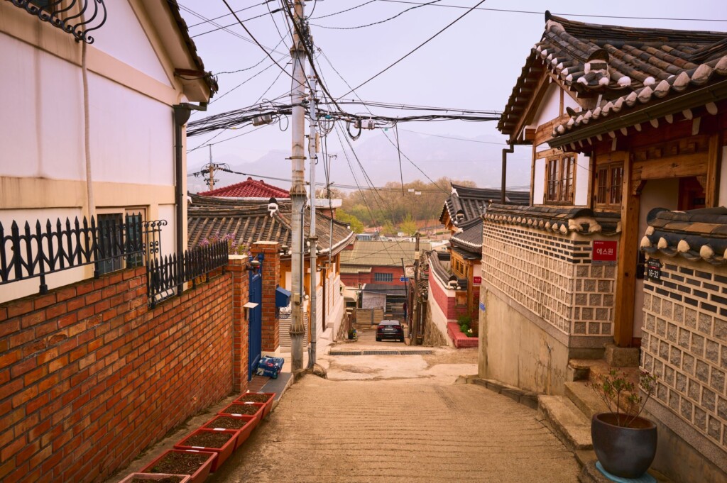 A misty 1930s-era Korean street evoking the colonial occupation period