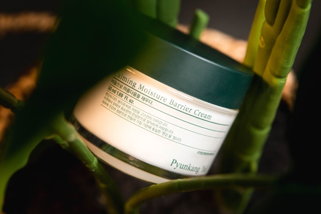 Autumn Korean skincare products arranged with maple leaves in warm light