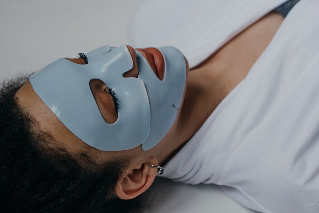 Young Korean woman applying moisturizer as part of her autumn skincare routine
